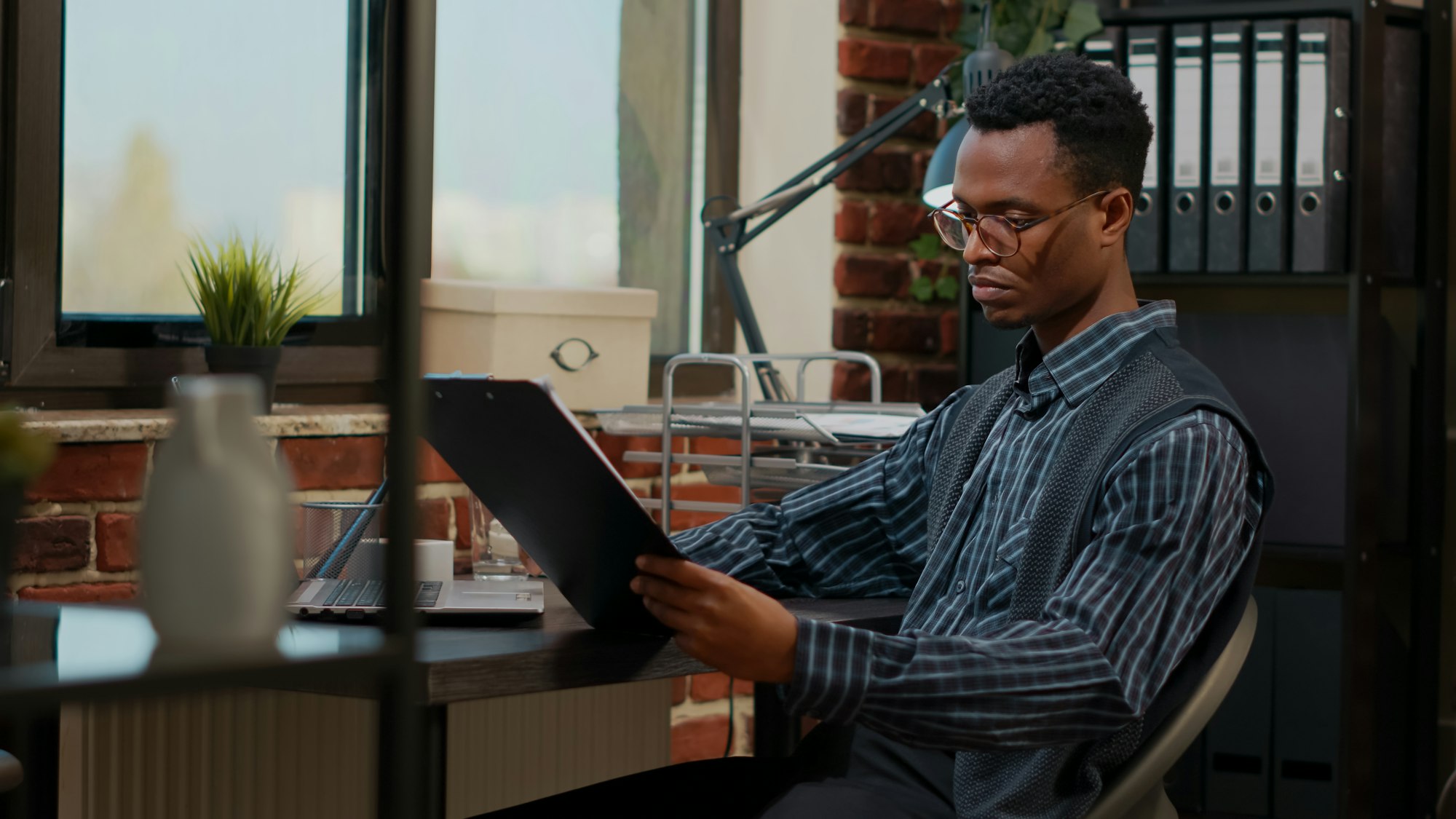 African american employee analyzing e shopping report